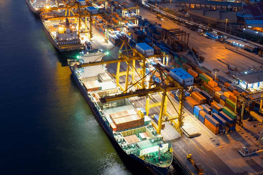 Night: Ocean cargo ship being loaded with FCL and LCL shipments