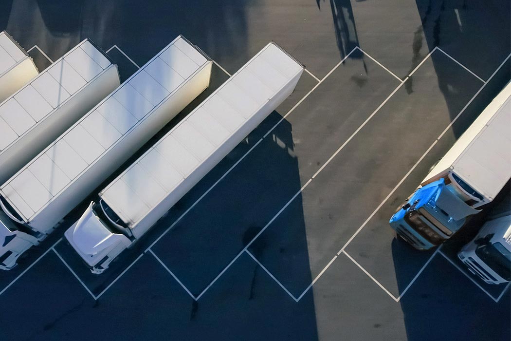 Trucks parked in a lot depicting  ways to save operating costs