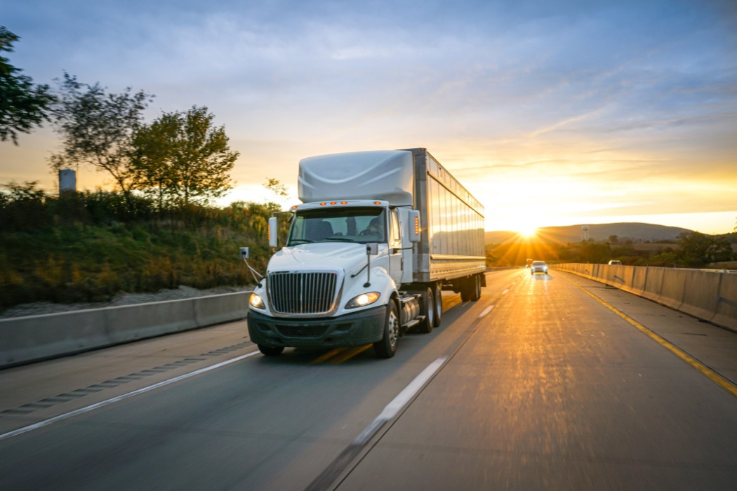 Truckload on the highway demonstrating relationship between shipper and carriers.