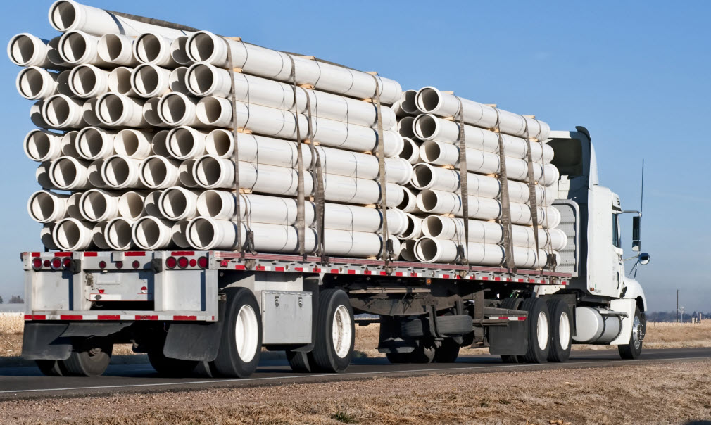 Flatbed truck with pipes
