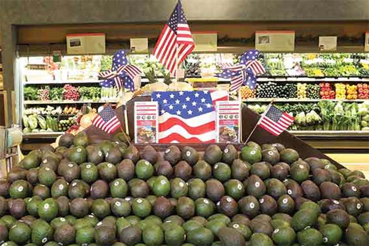 A pile of avocados at the grocery store.